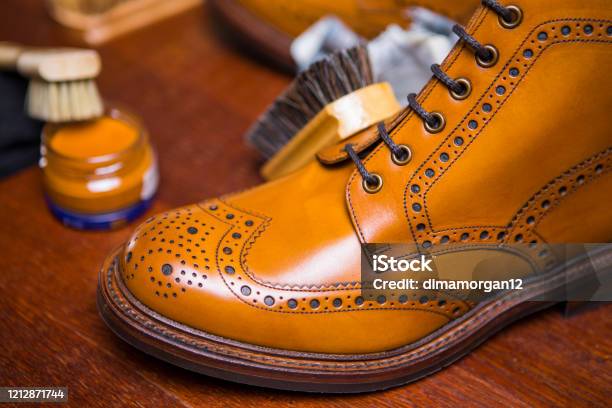 Extreme Closeup Of Premium Male Brogue Tanned Boots With Lots Of Cleaning Accessories On Foregroundhorizontal Composition Stock Photo - Download Image Now