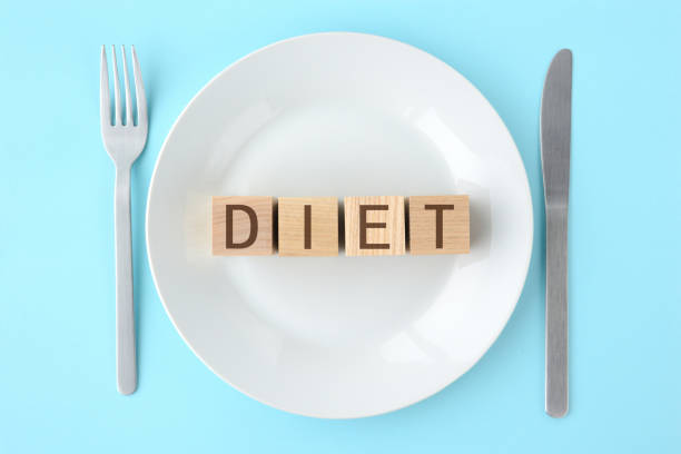 istock Wooden blocks with diet words on plate 1212873733