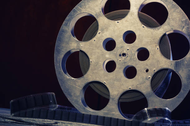 istock 35 mm film reel with dramatic lighting on a dark background 1212875633