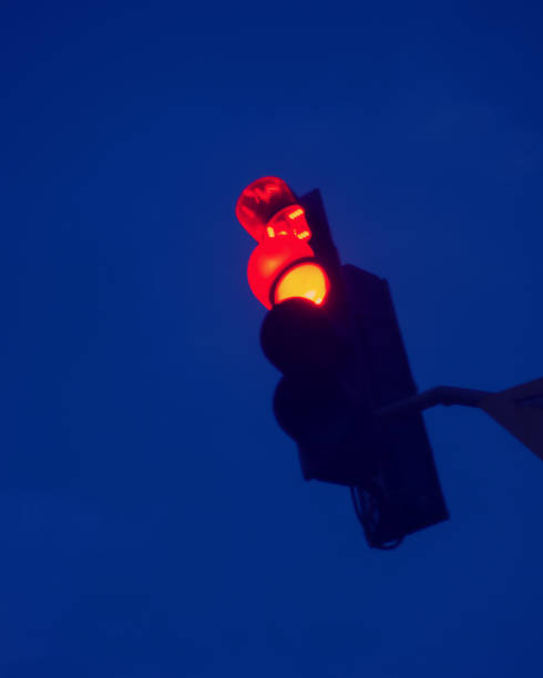 istock Blurred background, red light of traffic light in the night sky. 1212876984
