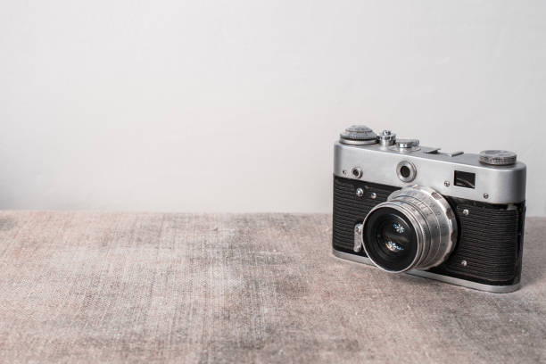Close up of Black Digital Rangefinder camera in indoor setting.