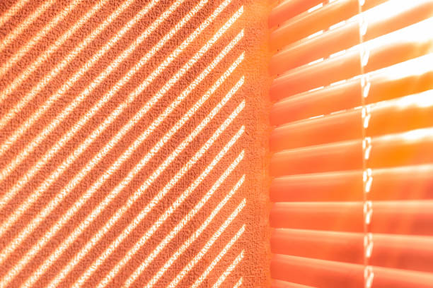 Shadow from the blinds on the wall. Sunlight through the blinds