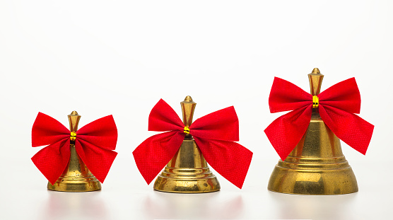 Christmas bell with a red bow isolated on white background