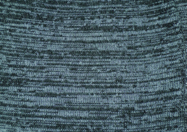 istock Mottled fabric as a background. Knitted fabric with stripes is grey and black. 1212878859