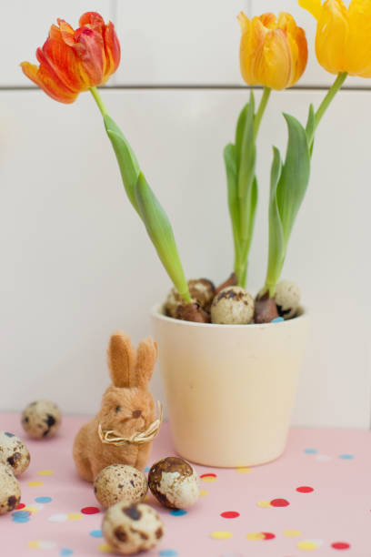 istock Easter bunny, quail eggs and tulips in a flower pot 1212880574