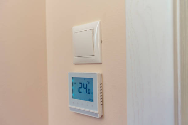 istock on the wall of the room there is a light switch and under it a floor heating switch with a temperature controller 1212881889