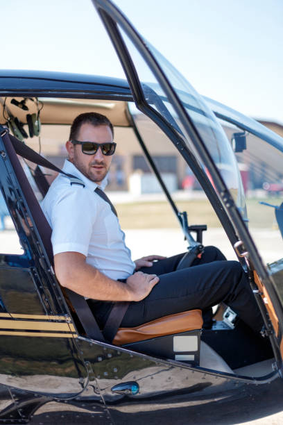 istock Pilot in uniform sitting in helicopter cockpit 1212883624