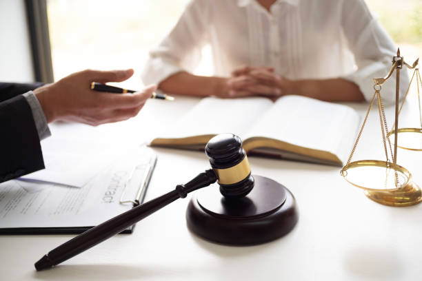 istock lawyer consulting with client discussing about lawsuit. 1212885733