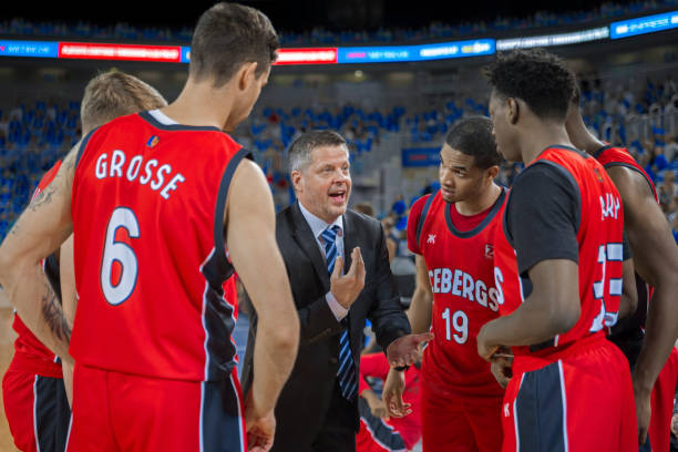 istock Coach giving instructions to basketball team 1212887516
