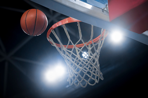 Close-up of basketball reaching to hoop in Arena Stozice, Ljubljana, Slovenia.