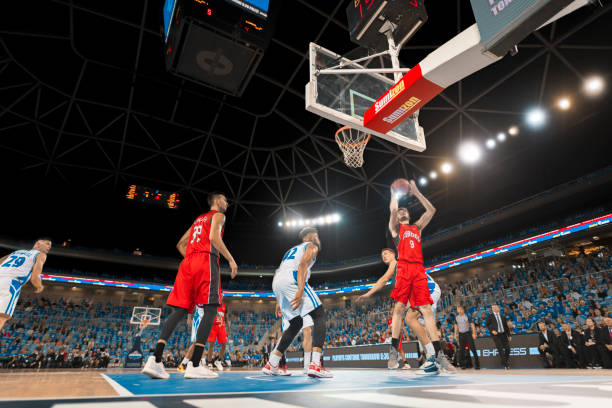 istock Basketball players playing on court 1212887612