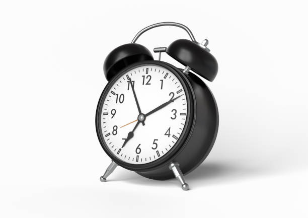 istock Black vintage alarm clock isolated on white background 1212889887