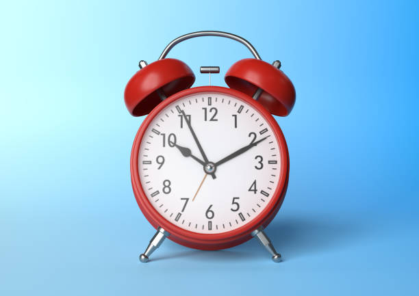 istock Red vintage alarm clock on bright blue background in pastel colors 1212889912