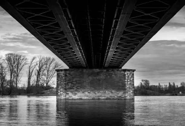 a bridge over a river in germany in black and white