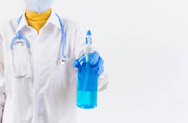 istock Doctor hands using washing hand with Alcohol Sanitizer and dust mask isolate on a white background. Protect themselves from virus infection in Corona virus crisis 2020 1212890088