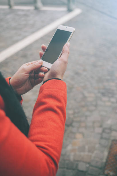 istock Woman in the street using her mobile 1212891157