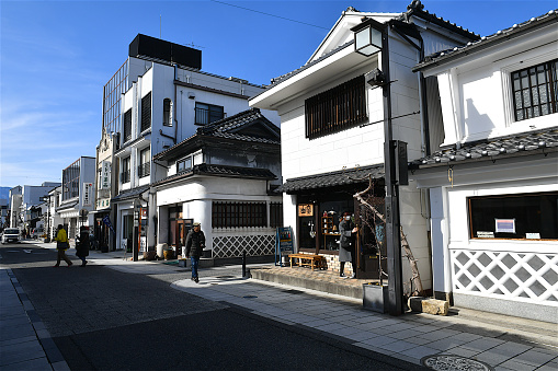 Matsumoto, Japan-01 26 2020:The Nakamachi-dōri district is Matsumoto's town center with streets lined by nicely preserved, old buildings. The buildings include a number of warehouse-type buildings with large white-painted walls. The area is where the city's merchants used to live during the Edo Period, and today, the types of buildings here reflect this history.