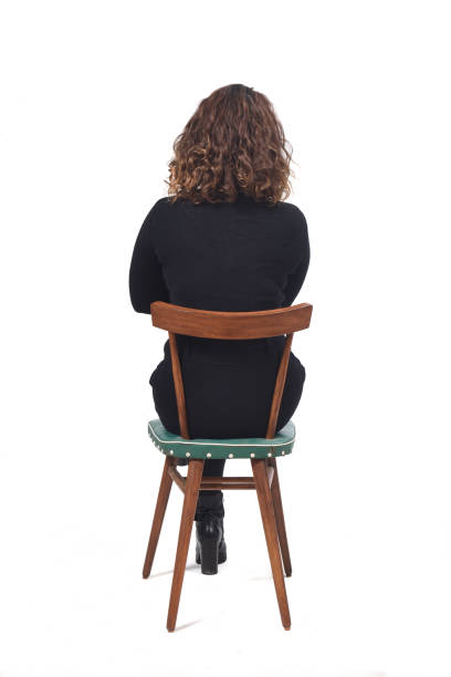 istock woman with chair on white background 1212897933