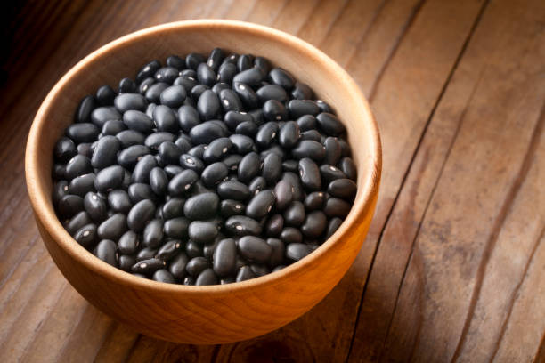 istock Black beans in wooden bowl 1212898167