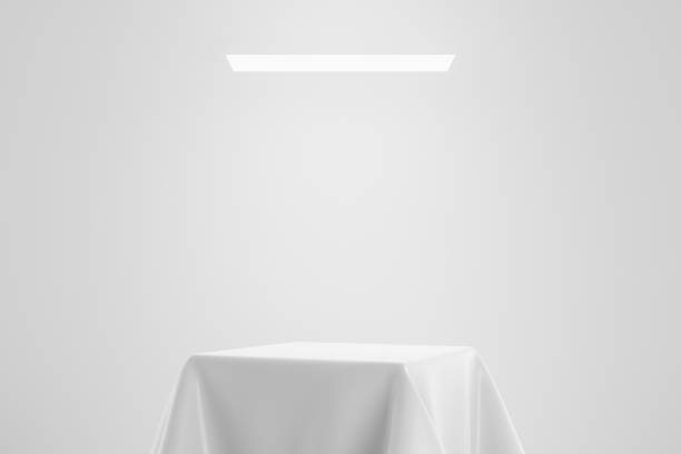 istock White fabric on pedestal or podium display with satin textile platform concept on studio background. Blank shelf stand for showing product. 3D rendering. 1212900444