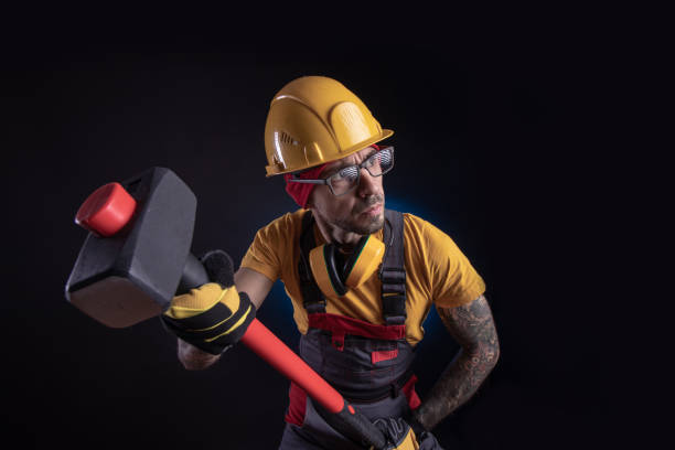 istock the male construction worker with a sledgehammer 1212900539