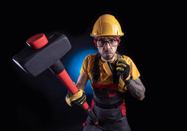 istock the male construction worker with a sledgehammer 1212900581