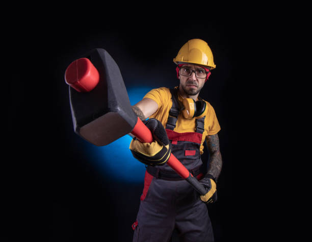 istock the male construction worker with a sledgehammer 1212900585