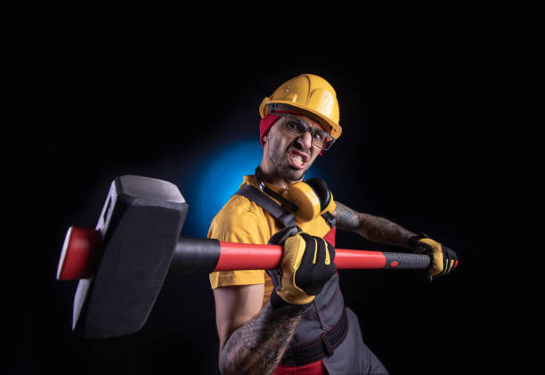 istock the male construction worker with a sledgehammer 1212900586
