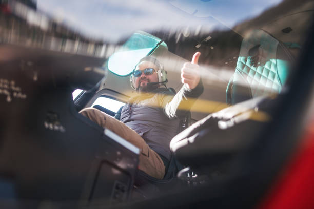 istock Man inside a helicopter cockpit with thumbs up sign 1212901451