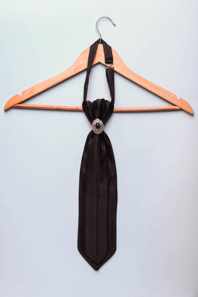 istock Wedding black tie with a brooch ring on a wooden hanger 1212902179