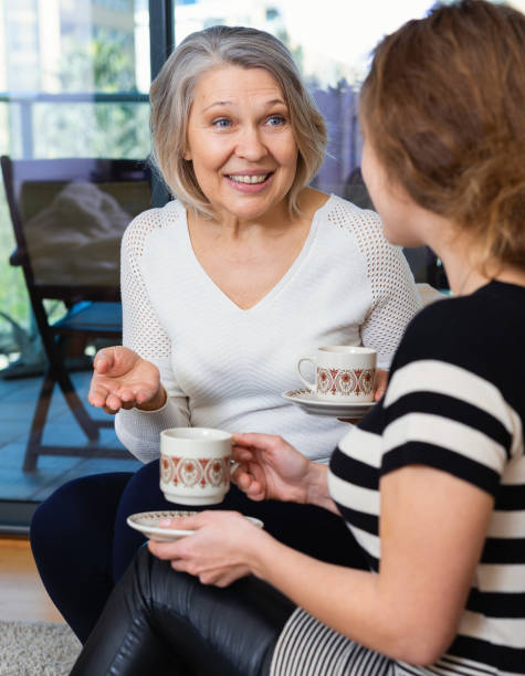 istock Two women talking at home 1212903670