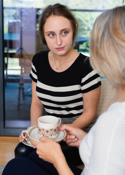 istock Two women talking at home 1212903968