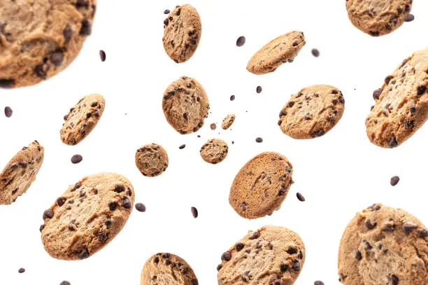 Photo of Chocolate chip cookie falling isolated on white background. Selective focus