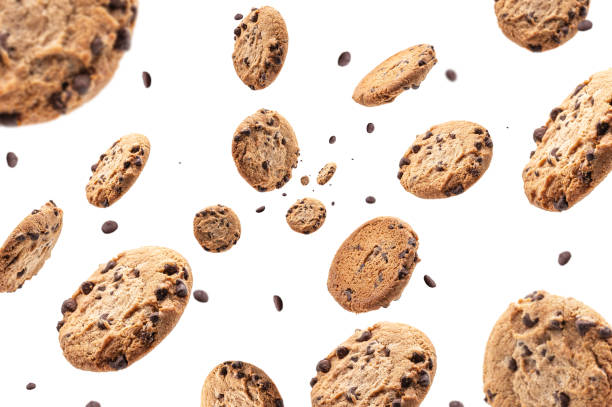 chocolate chip cookie falling isolated on white background. selective focus - freshly squeezed imagens e fotografias de stock