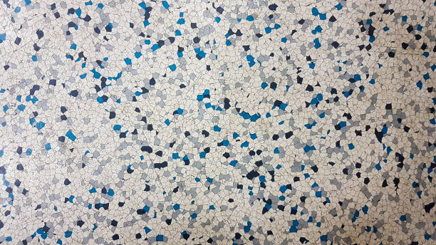 istock Floor covering with rubber granules. Special rubber coating for the playground. Multi colored rubber crumb closeup background 1212905423