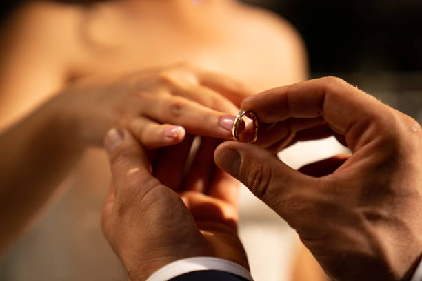 istock groom and bride put on each other rings. wedding. 1212906790