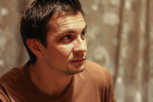 istock Portrait of a young thinking man at home 1212906843
