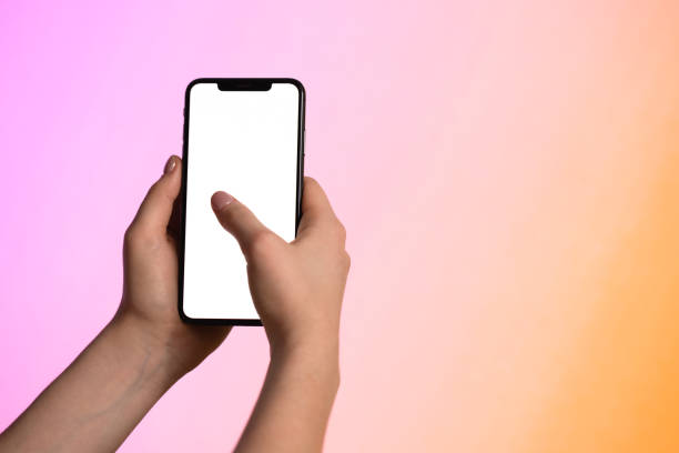 istock Close up of female hands using smartphone with white screen mobile phone for graphic display montage 1212907293