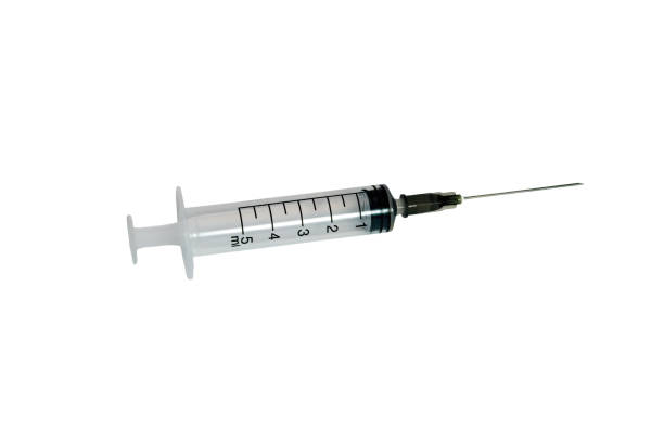 istock Disposable medical syringe. Isolate on a white background. Close-up. 1212908057