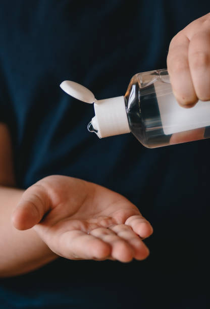 istock Girl using hand sanitizer liquid 1212908235