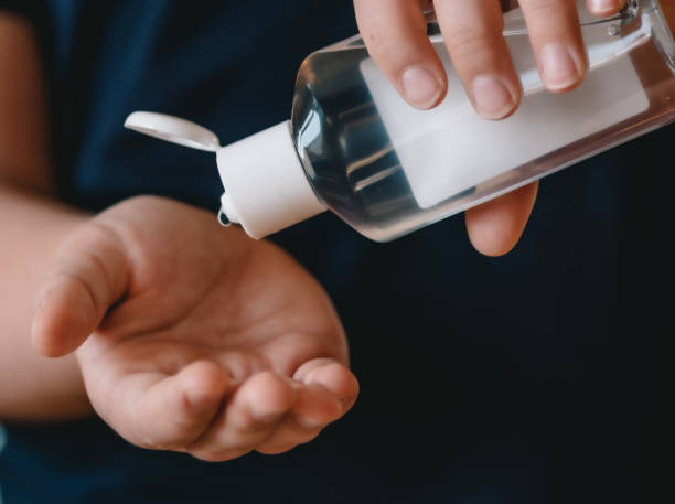 istock Girl using hand sanitizer liquid 1212908239