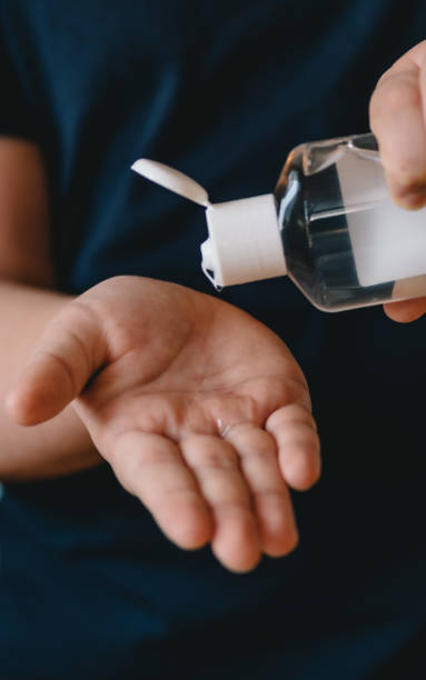istock Girl using hand sanitizer liquid 1212908258