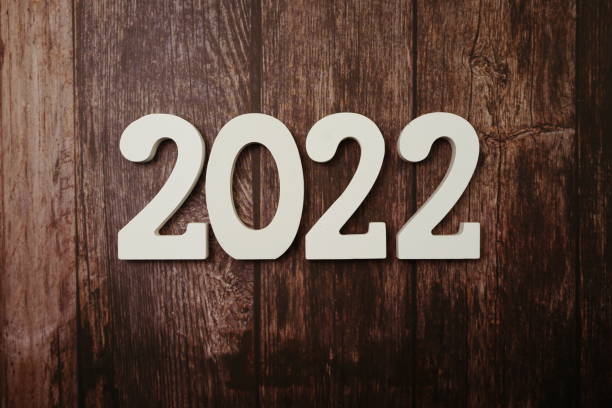 istock 2022 Happy New Year with space copy on wooden background 1212908686