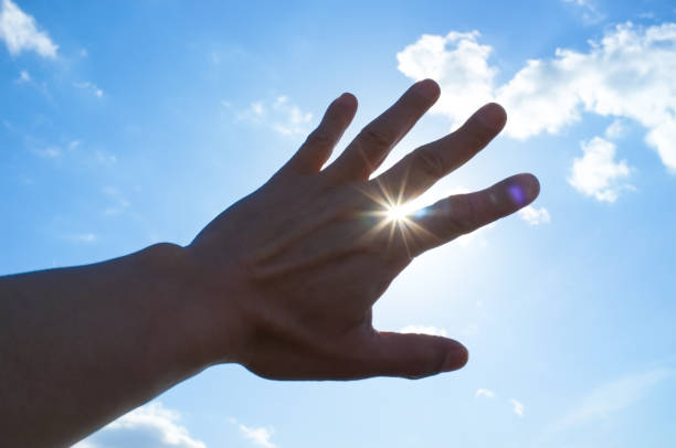 istock Man's hand and the sun 1212909629