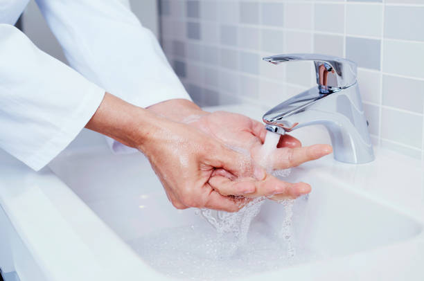 istock doctor man washing his hands in a sink 1212912078
