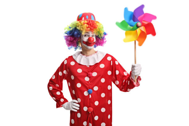 istock Clown holding a colorful spinning pinwheel 1212913219