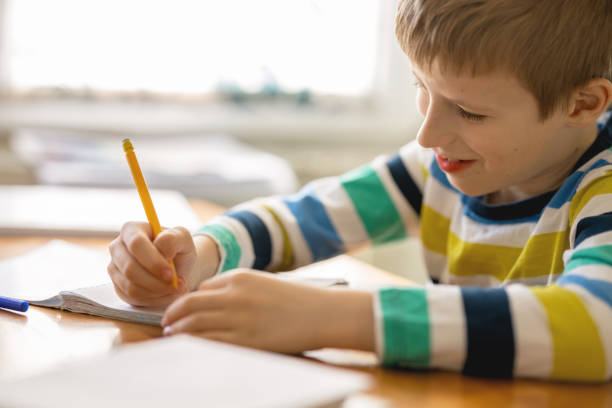 istock Little Boy Doing Homework at Home 1212913998