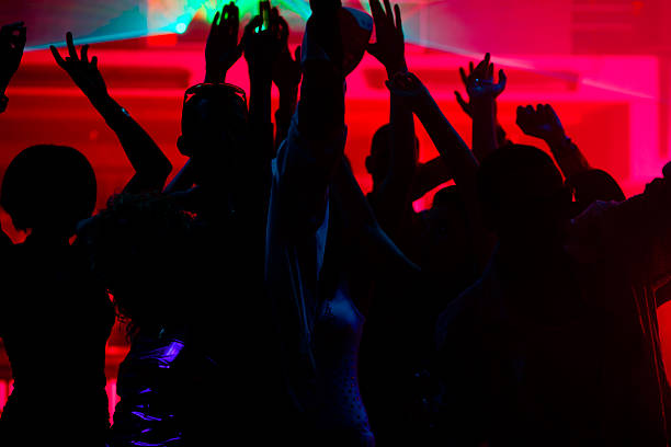istock People dancing in club with laser 121291570