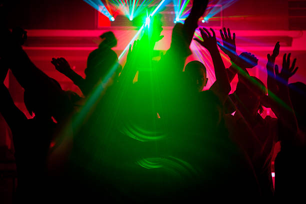 istock People dancing in club with laser 121291573