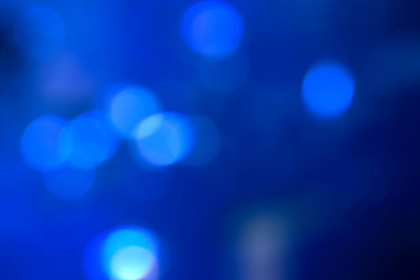 Blurry blue Christmas lights. Lights out of focus. Christmas and New Year abstract background. Template for custom design. Festive wallpaper.